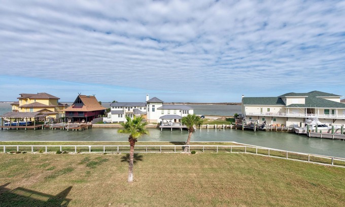 Port Aransas Condo | Drink your morning coffee on the deck watching the ships pass by.