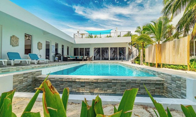 San Pedro House | Escape to this stunning 4-bedroom villa nestled on the white sands of northern Ambergris Caye, Belize.