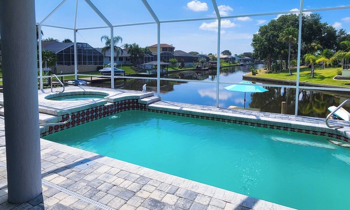 Palm Harbor House | Five Star 3bd Waterfront Canal Home w/Private Pool/Spa & Boat Dock.