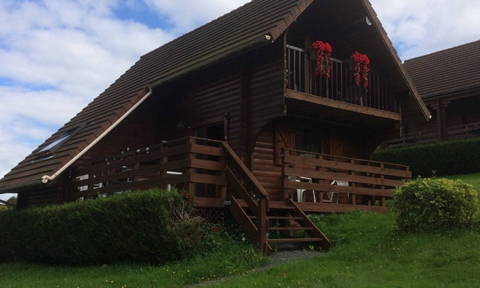 Saint-Germain-de-Tallevende-la-Lande-Vaumont Ski Chalet | Traditional Log Cabin on quiet Residential Commune overlooking Lake Dathee