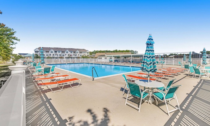 The Glade House | Grande at Canal Pointe home with patio, grill, fireplace, outdoor pool & tennis