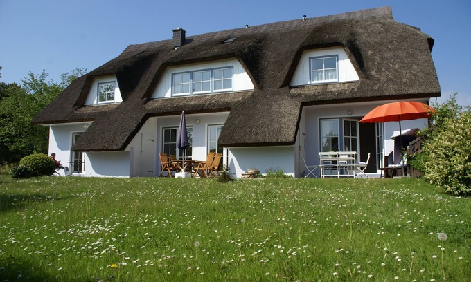 Putbus House | Holiday house thatched with reed in natural reserve area with garden and terrace