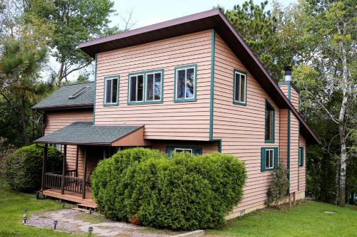 Tomah House | Lakefront Cabin Rental with a Paddle Boat near Wisconsin Dells, Wisconsin