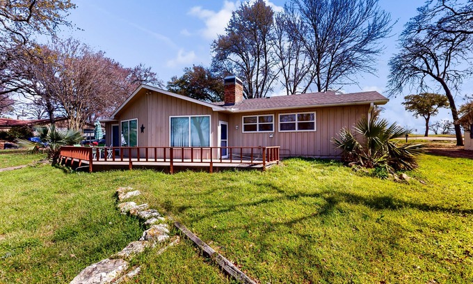 Kemp House | Lakefront retreat near golf course with serene wraparound deck, fireplace, & AC