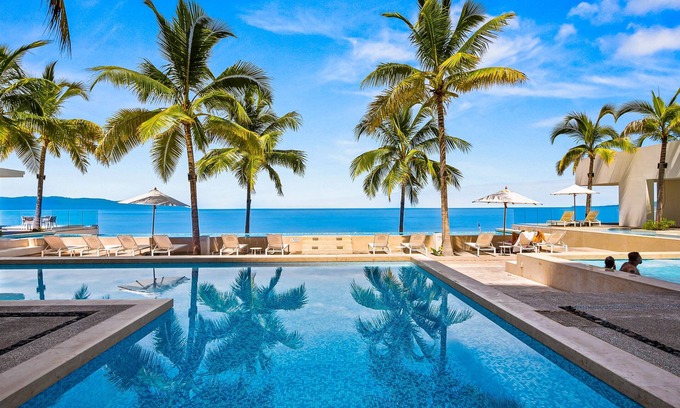 Las Glorias Apartment | Luxe beachfront condo with balcony, multiple pools, ocean views, & WiFi