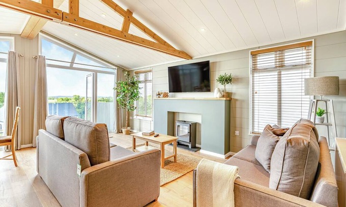 Middlezoy Ski Chalet | Luxurious lodge with vaulted ceilings and a welcoming feature fireplace.