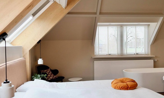 Appeltern Hotel | Luxurious suite with river meadow views, modern amenities, and an elegant, relaxing atmosphere.