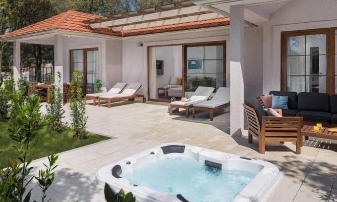 Bale House | Luxury Bay Villa with private hot tub by Interhome