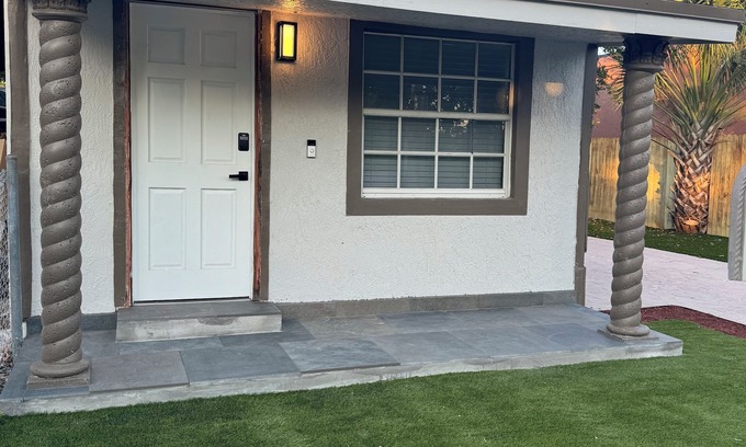 Liberty City House | Modern home with driveway parking and fenced yard.