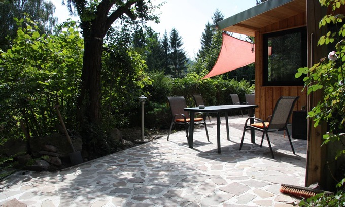 Friedrichroda House | Modernly furnished bungalow with fireplace, surrounded by greenery.