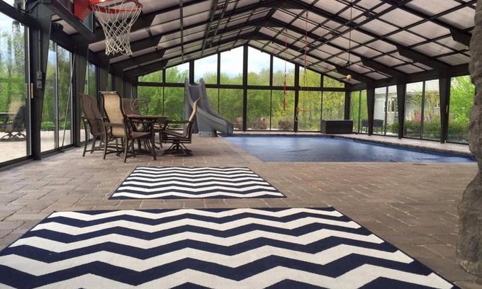 Fond du Lac House | Most Fun Home in Wisconsin: Indoor Heated Pool, Basketball Court, Rock Climbing Wall, Ropes/Obstacle Course, Play-Set, Trampoline, Fire-Pit, Grill, Patio, 84 inch TV, and so much more!