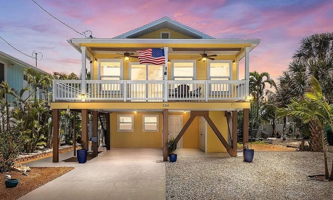 Fort Myers Beach House | Ostego Charm: Open floor plan, porch, lush landscape—walk-able to the Beach!