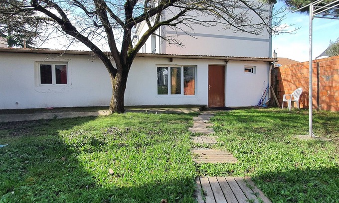 Les Luats Apartment | Pleasant outbuilding in front of a garden in a quiet area