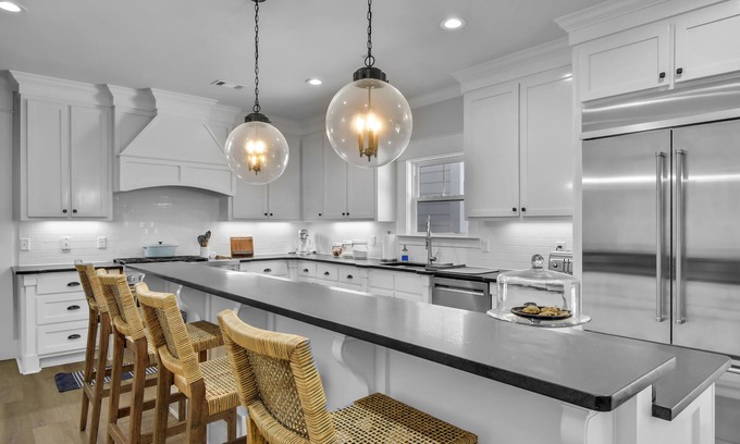 Saint Simons Island House | Private expansive backyard with pool, putting green and outdoor kitchen