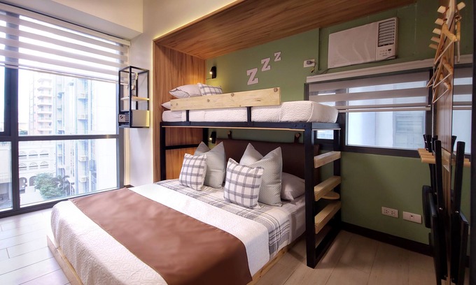 Bonifacio Global City Condo | Relax to a family size condo with fun games, popcorn and cinematic movie.