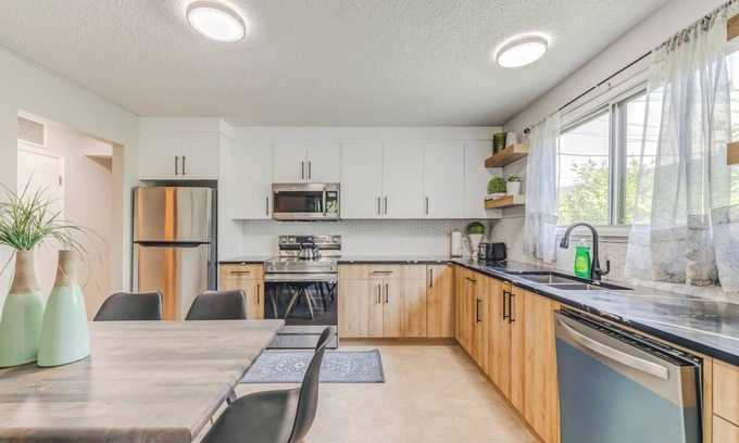 Crescent Heights Apartment | Renovated 3 bed, 2 bath! Walk downtown, HOT TUB and close to the Airport!