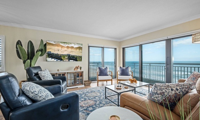 New Smyrna Beach Condo | Renovated direct oceanfront corner condo with a huge wrap-around balcony and pool