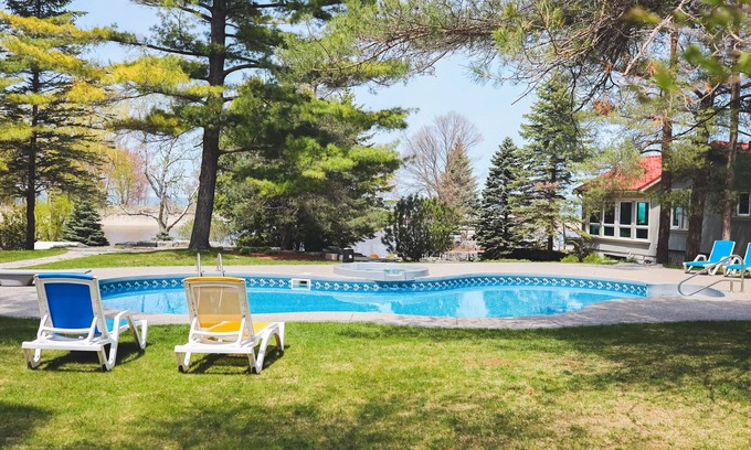 Wasaga Beach Apartment | River View cozy studio cottage with loft, steps shared pool, beach, & firepit