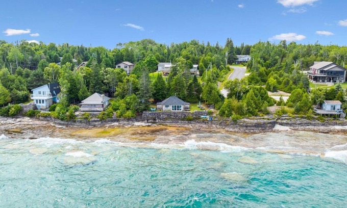 Lion's Head House | Seafari is a charming stone cottage on Georgian Bay with stunning bluff views, a flat rock shoreline, and a cozy bunkie. Perfect for relaxing, swimming, and exploring.