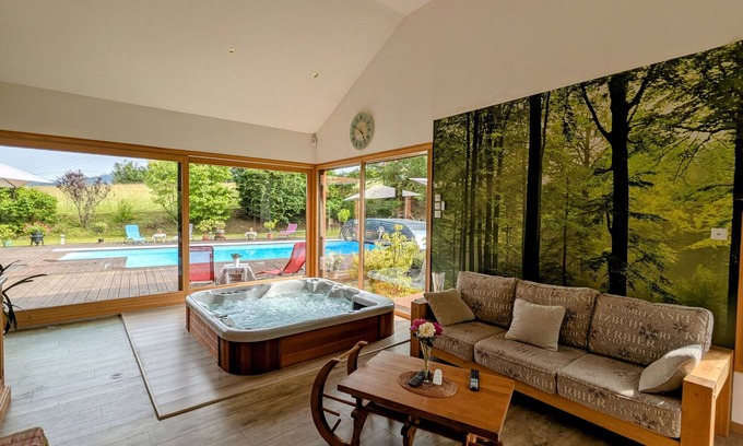 Anould Bed & Breakfast | Spacious room with balcony and heated pool access