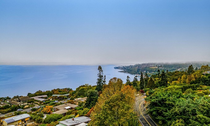 Innis Arden House | Spectacular mid-century home with two-story fireplace, huge deck, & water views