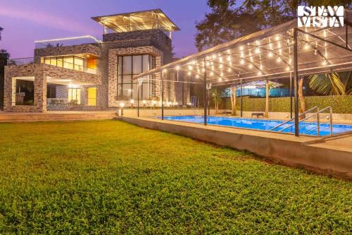 Kune Village Villa | StayVista's Greystone Estate with Pool, Theater, Terrace, and Snooker Table