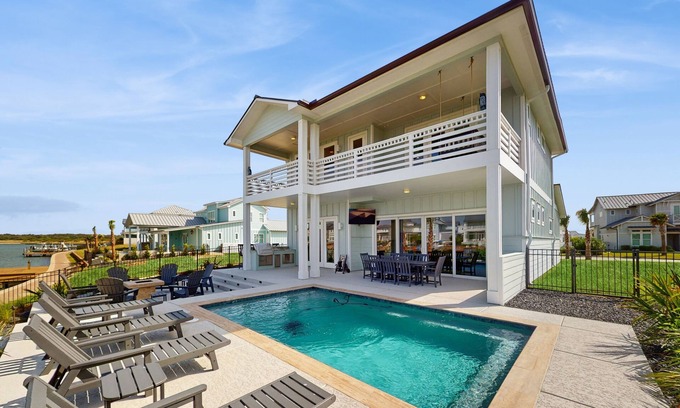 Rockport House | Stunning canal front home with private pool, fire pit, and boat dock