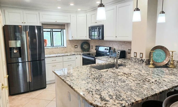 Central Naples Condo | Stunning Condo in Naples Bath & Tennis-Lake Views-Pool & Hot Tub-Great Location!
