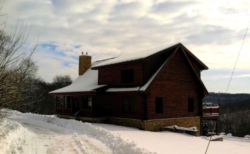 Eldorado House | Stunning Log Cabin Rental with a Fireplace near the Volga River State Recreation Area, Iowa