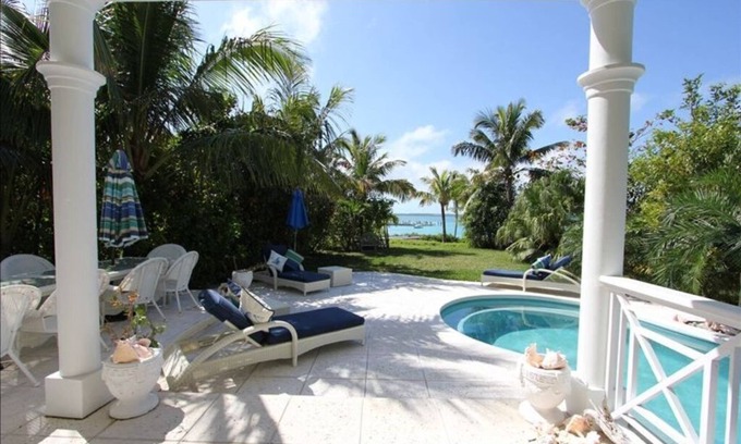 Dunmore Town House | Stunning waterfront property with panoramic sunset views + pool + dock