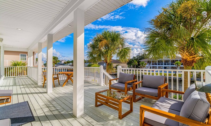 Siguenza Cove House | Stylish canal-front home with game room, firepit, fireplace, W/D & boat slip