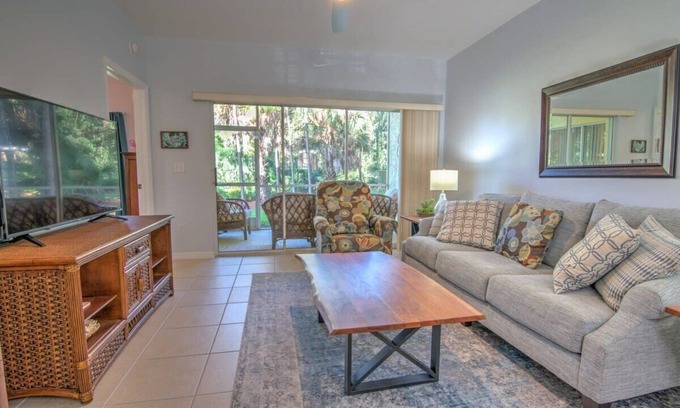 Ole Condo | Sunny Coral Falls With Vibrant Tropical Colors