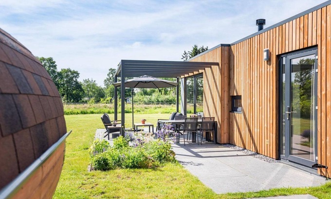 Kotten House | The 6-person holiday villa Amalia with a private sauna has a spacious living room, an open kitchen, three bedrooms, and a spacious terrace.