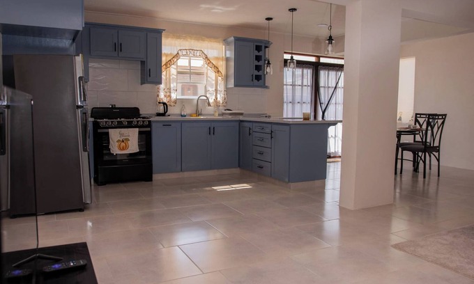 Ragged Point Apartment | The apartment features an open plan living and dining area, and a spacious and modern kitchen.