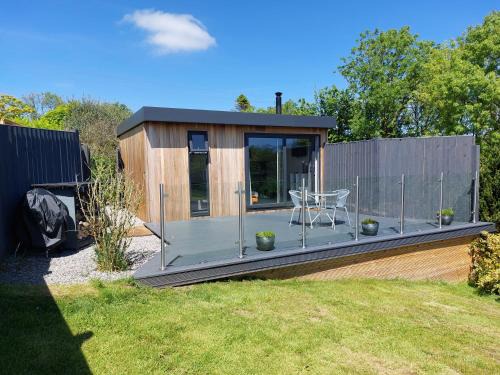 Amroth Apartment | The Den - Modern cabin with wood burning stove