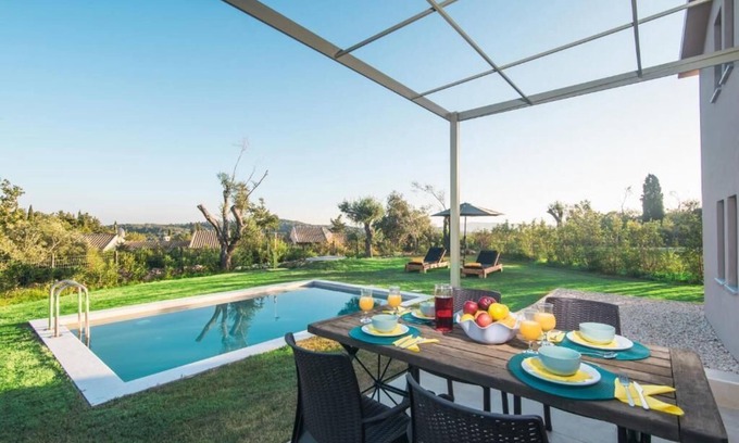 Doukades Villa | The villa's large private garden leads directly to the outdoor private pool.