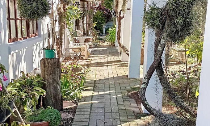 Mossel Bay House | This cozy home is nestled in a beautiful secret garden.