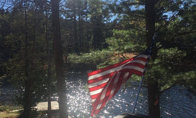 South Boardman Cottage | Traverse City area Lakefront Log Home, FREE Hot Tub, WIFI, & Boats.