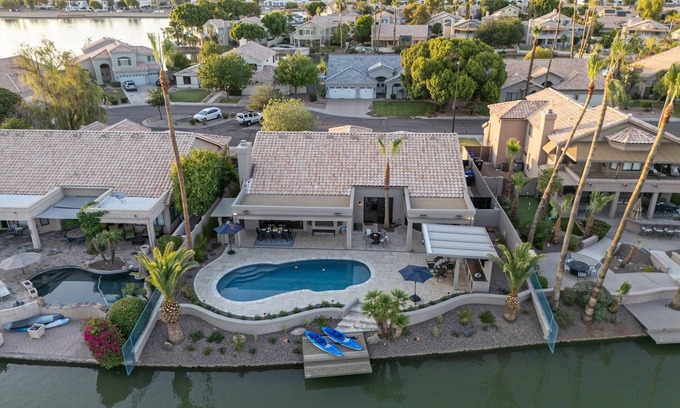 Crystal Shores House | Val Vista Lakefront Gem, Game Room, Htd Pool, Patio TV, Fire Pit, Kayaks, Bikes