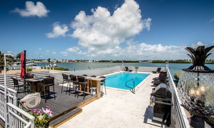 Key Colony Beach House | Watch dolphins play in Shelter Cove while swimming in our oversized pool