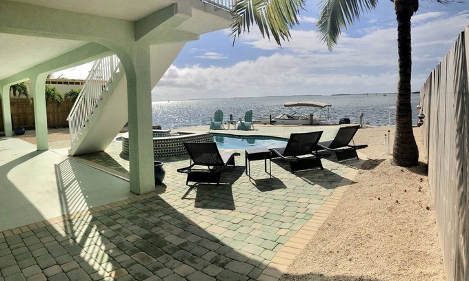 Breezeswept Beach Estates House | Water Front Home. Direct deep water access with private pool/spa/dock & Elevator