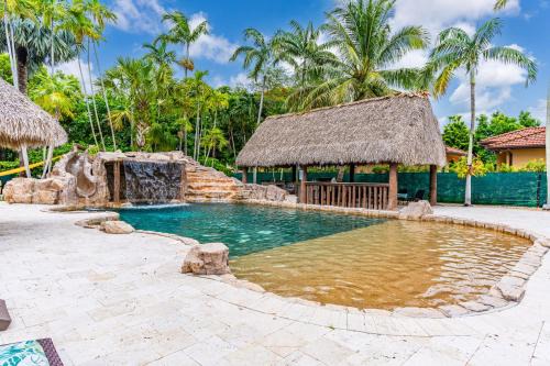 University Park House | Waterfall Cove- resort pool with slide and waterfall