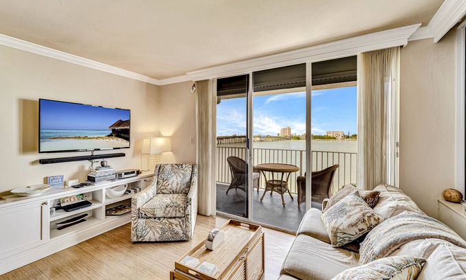 Fort Myers Beach Condo | Waterfront condo with private beach area, pool, hot tub, grills, & balcony