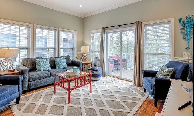 Waters Edge House | Welcoming water view townhome with pool, balcony, deck, & kitchen