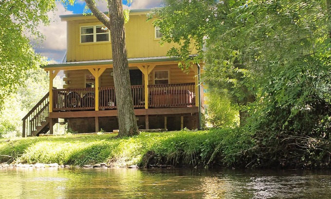 Newport Cabin | Yellow Cabin on the River: Pet Friendly, Free Attraction Tickets, Hot Tub & River Access