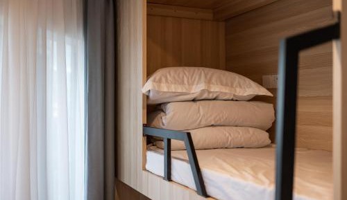 Bed in 8-Bed Male Dormitory Room with Shared Bathroom