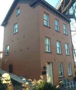 Poughkeepsie Apartment | Brick house under the walkway.