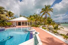Marsh Harbour House | Emerald Moon Cottage - Beachfront rental with infinity pool, 35' private deep water dockage, 6' LWD & back up generator. Located in the exclusive gated community of Sunrise Bay