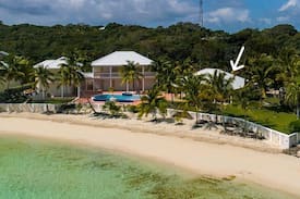 Marsh Harbour House | Emerald Moon Cottage - Beachfront rental with infinity pool, 35' private deep water dockage, 6' LWD & back up generator. Located in the exclusive gated community of Sunrise Bay