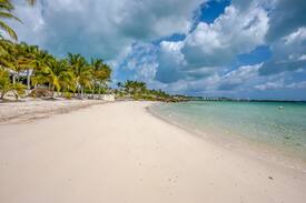 Marsh Harbour House | Emerald Moon Cottage - Beachfront rental with infinity pool, 35' private deep water dockage, 6' LWD & back up generator. Located in the exclusive gated community of Sunrise Bay